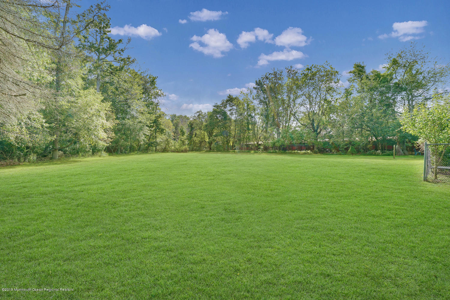 49 Evergreen Drive Jackson, NJ 08527 - Photo 29 of 50 a view of a grassy field with trees in the background