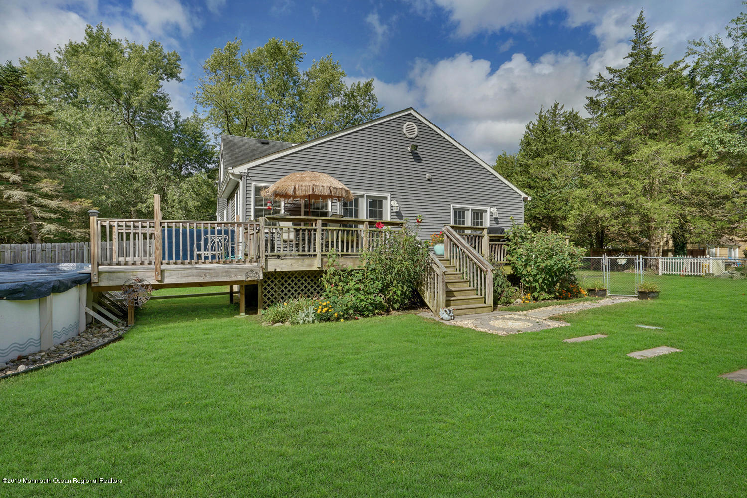 49 Evergreen Drive Jackson, NJ 08527 - Photo 40 of 50 a front view of a house with a yard and fence