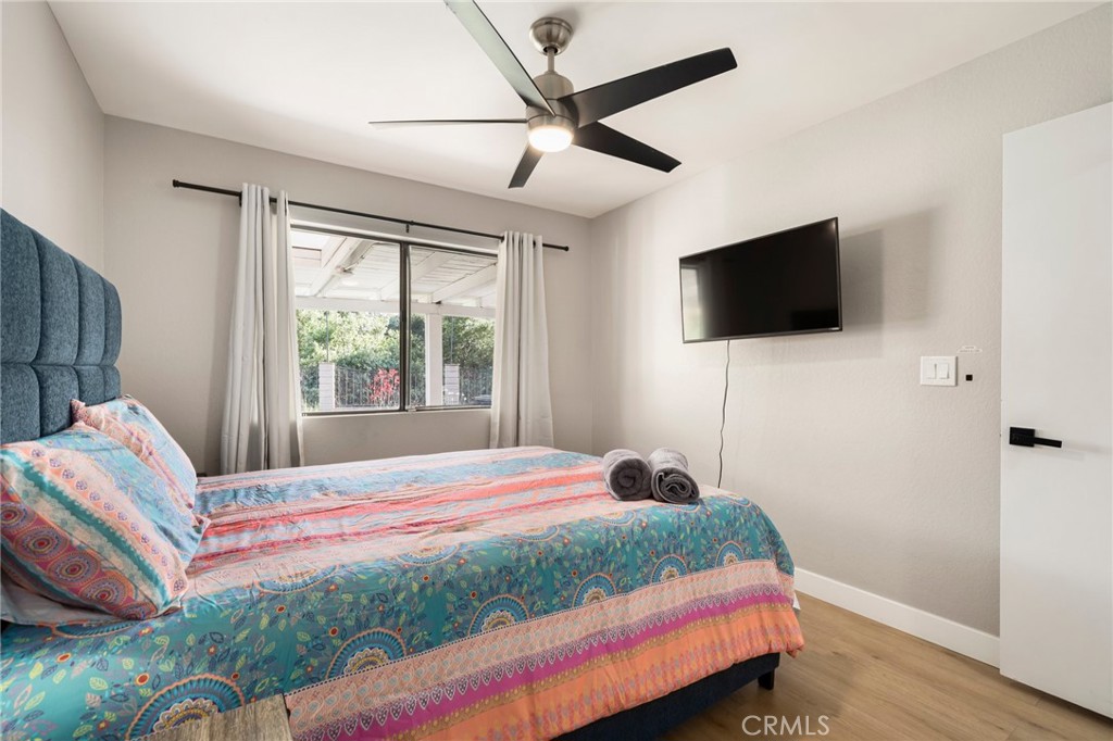 1128 Dawn Ridge Way Covina, CA 91724 - Photo 18 of 32 a bedroom with a bed a flat screen tv and a window