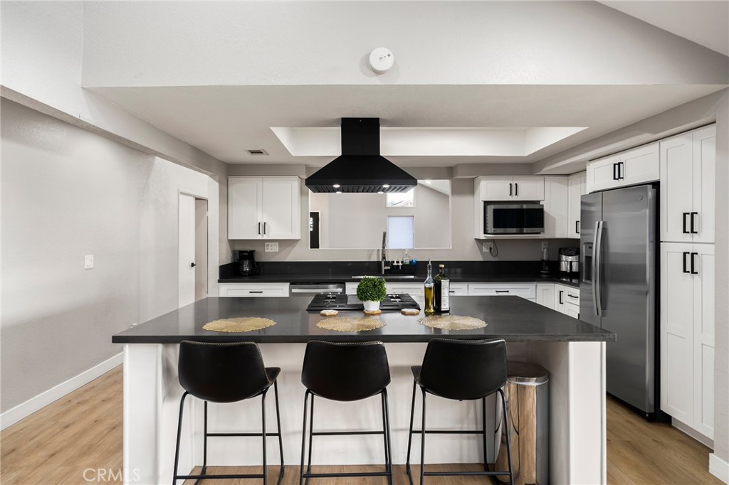 1128 Dawn Ridge Way Covina, CA 91724 - Photo 9 of 32 a kitchen with a dining table and chairs