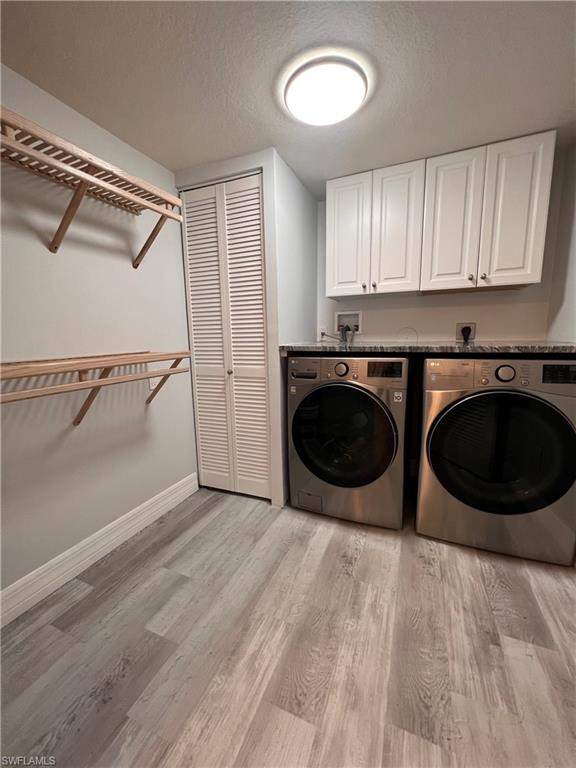 409 Gabriel Circle, Unit 2203 Naples, FL 34104 - Photo 12 of 18 a kitchen with a stove top oven and cabinets