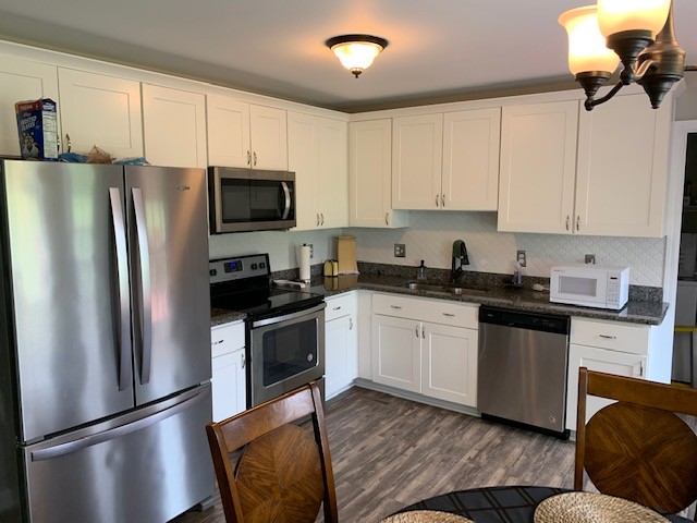 306 Scattersville Road Portland, TN 37148 - Photo 8 of 16 a kitchen with stainless steel appliances granite countertop a refrigerator a stove top oven a sink and dishwasher