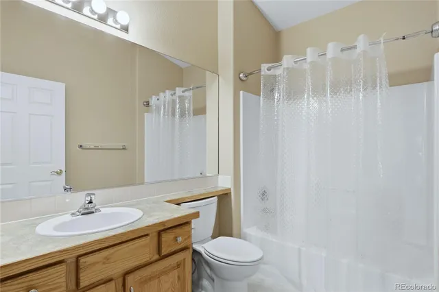 a spacious bathroom with a double vanity sink a large mirror and a bathtub