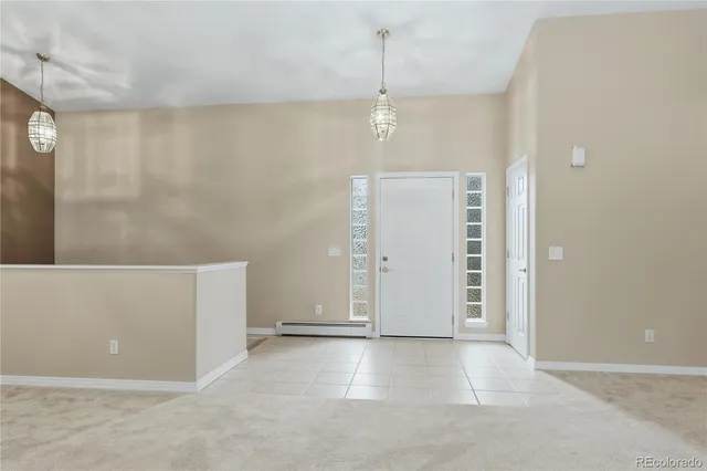 wooden floor in an empty room with a bathroom