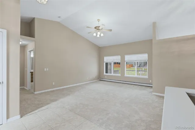 an empty room with a ceiling fan and a window