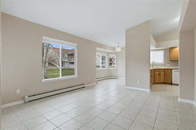 a view of a kitchen with furniture and an empty room