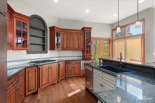 a bathroom with a granite countertop sink a mirror and a shower