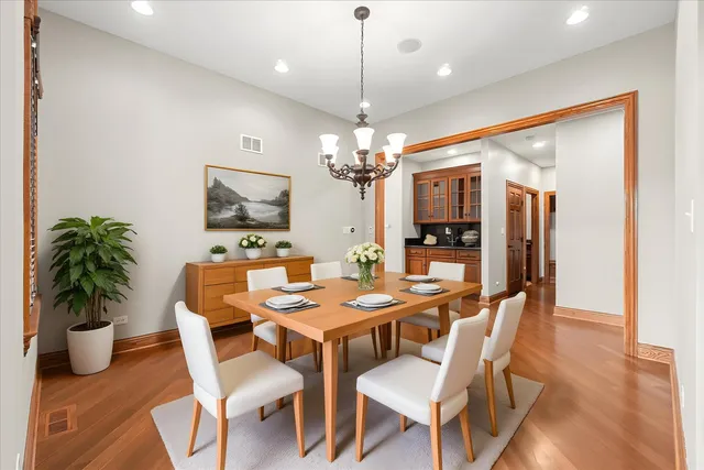 a kitchen with stainless steel appliances granite countertop a refrigerator a sink and wooden cabinets