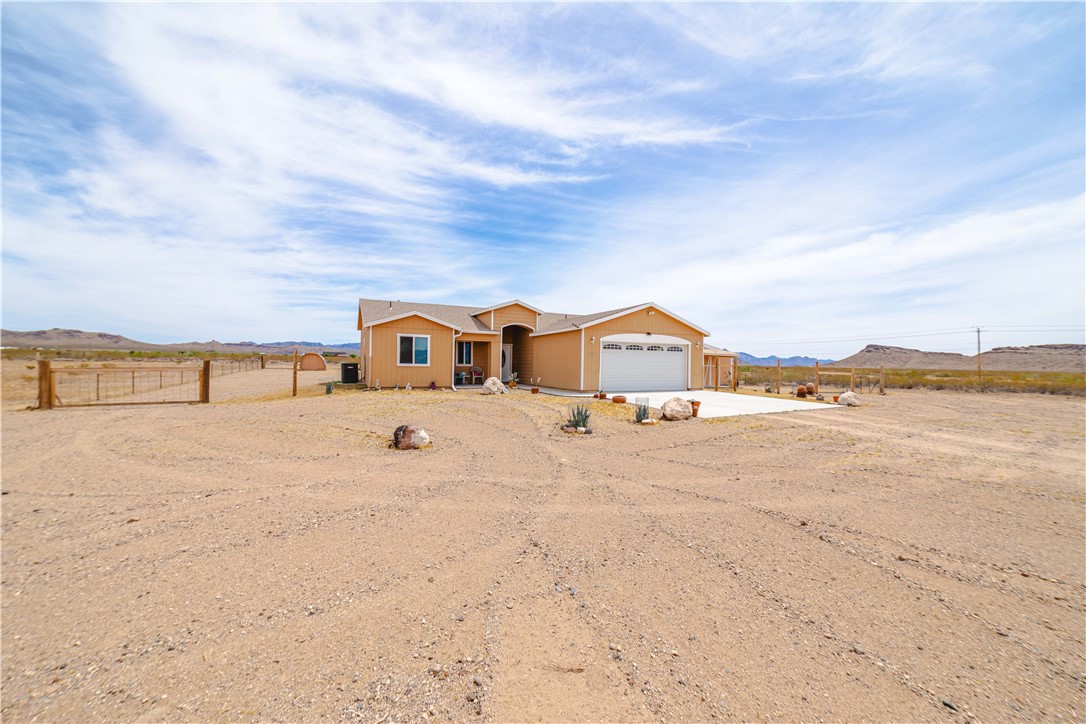 2948 Pinal Road Golden Valley, AZ 86413 - Photo 51 of 59 Single-story residence featuring a two-car garage with a white overhead door