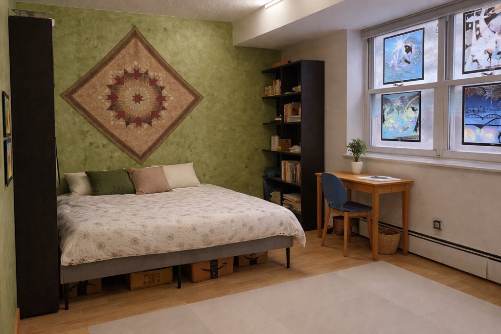 100 Marion Street, Unit B Brookline, MA 02446 - Photo 6 of 9 a bedroom with a bed and a table in it