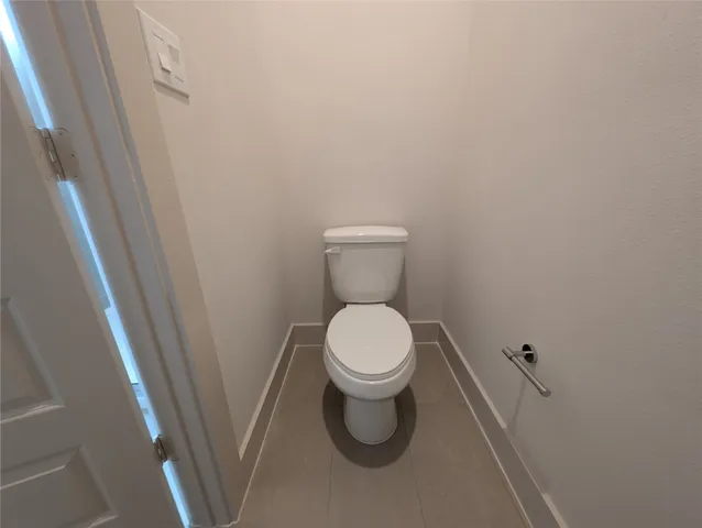 a white toilet sitting next to a sink