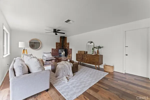 a living room with furniture a rug and a wall painting