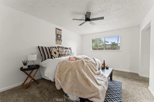 a bedroom with a bed and a painting on the wall