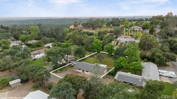 an aerial view of a house with a yard