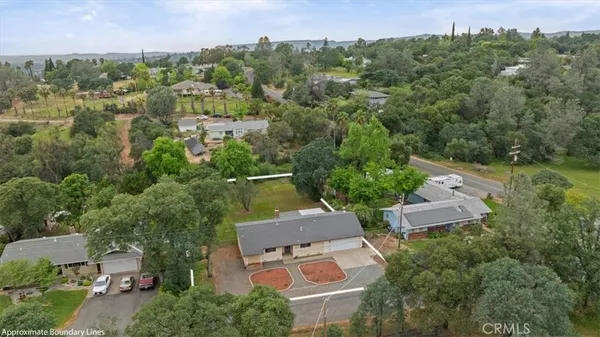 an aerial view of a house with a yard