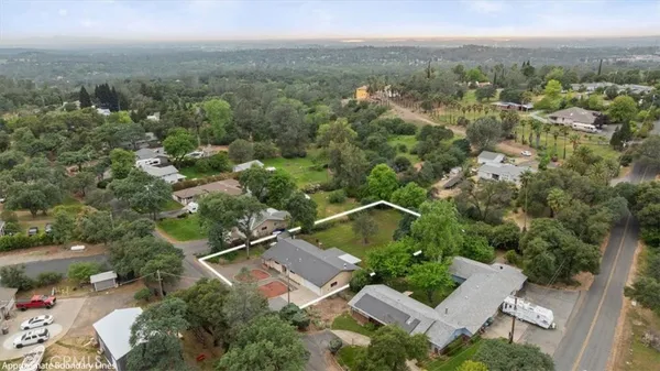 an aerial view of a house with lots of trees