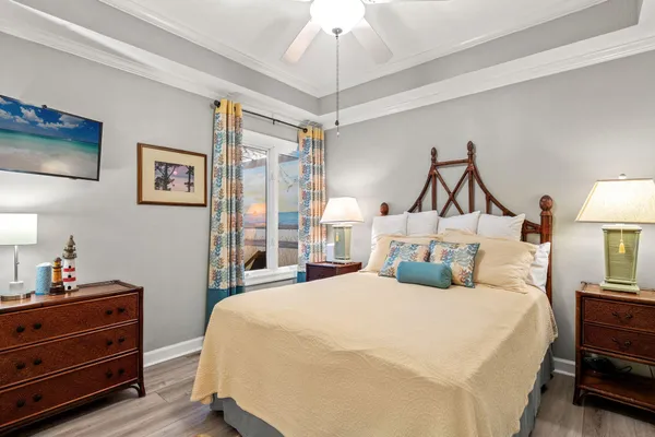 a bedroom with a bed and a chandelier