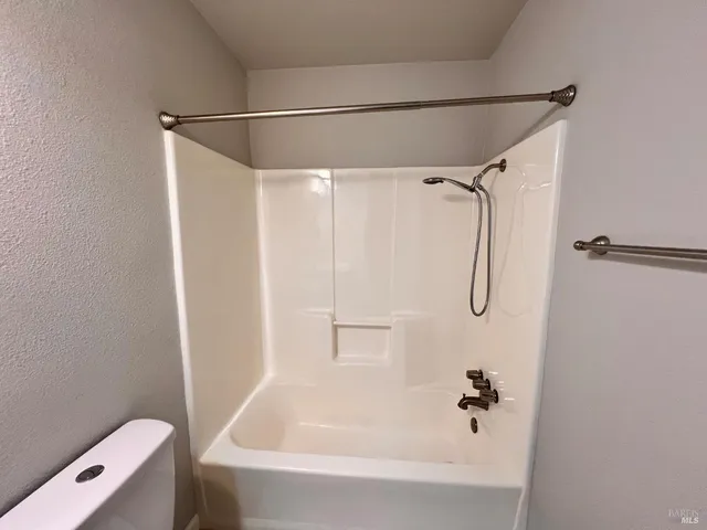 a bathroom with a shower and a tub