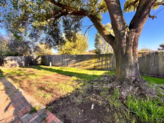 a view of yard with swimming pool and trees