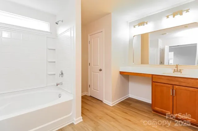 a bathroom with a bathtub a sink and a mirror
