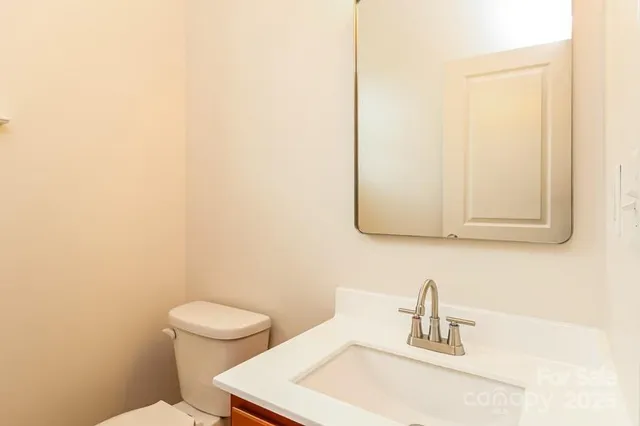 a bathroom with a sink a toilet and mirror