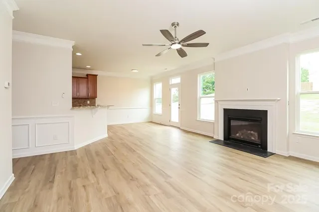 a view of a livingroom with a fireplace and window