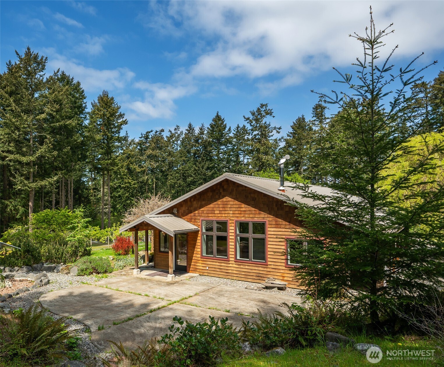343 Burt Road Lopez Island, WA 98261 - Photo 1 of 39 a front view of a house with a yard