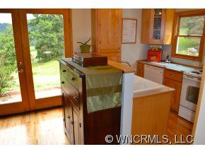 187 Jaynes Mtn. Road Canton, NC 28716 - Photo 14 of 24 a bathroom with a sink a mirror and next to a window
