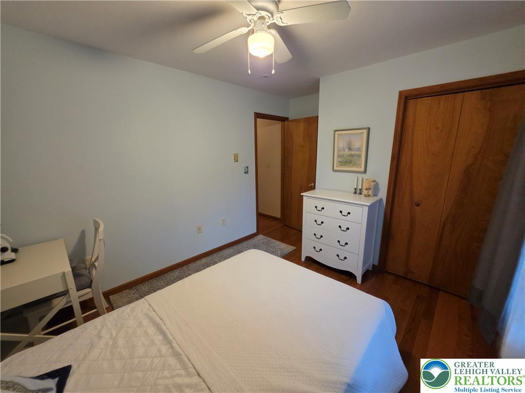 211 Murphy Circle Bushkill, PA 18324 - Photo 20 of 28 Well-lit sleeping quarters with a ceiling fan, hardwood floors, and ample closet space.