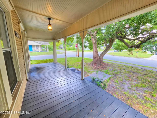 a view of an entryway with wooden floor and fence
