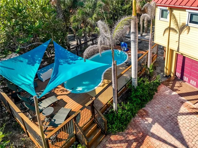an aerial view of a house with a yard and lake view