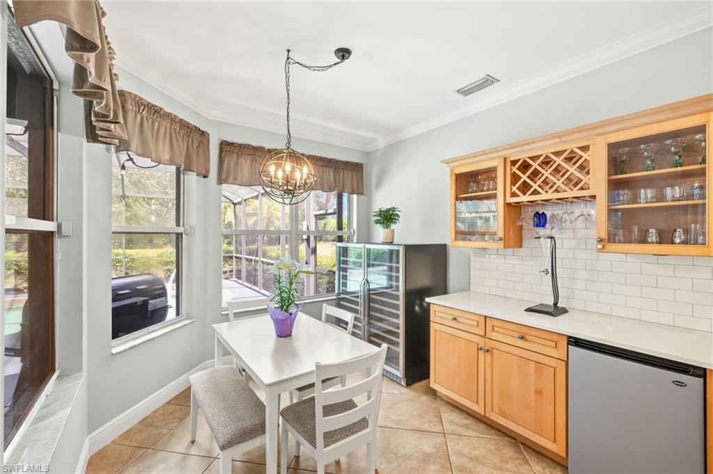 9890 Rookery Circle Estero, FL 33928 - Photo 13 of 26 a kitchen that has a lot of furniture and windows