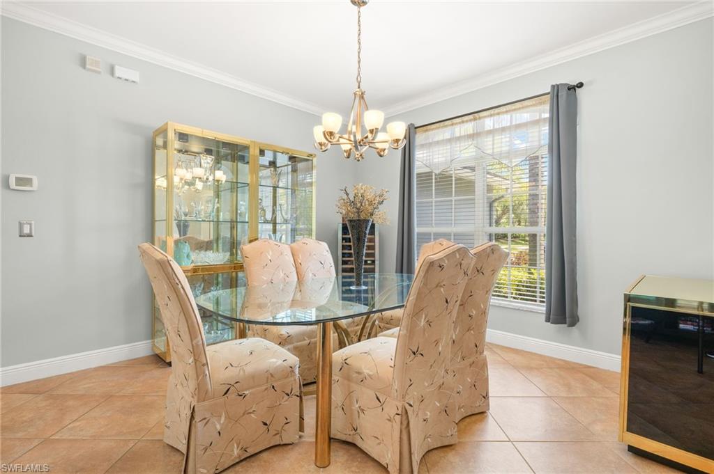 9890 Rookery Circle Estero, FL 33928 - Photo 14 of 26 a dining room with furniture and chandelier