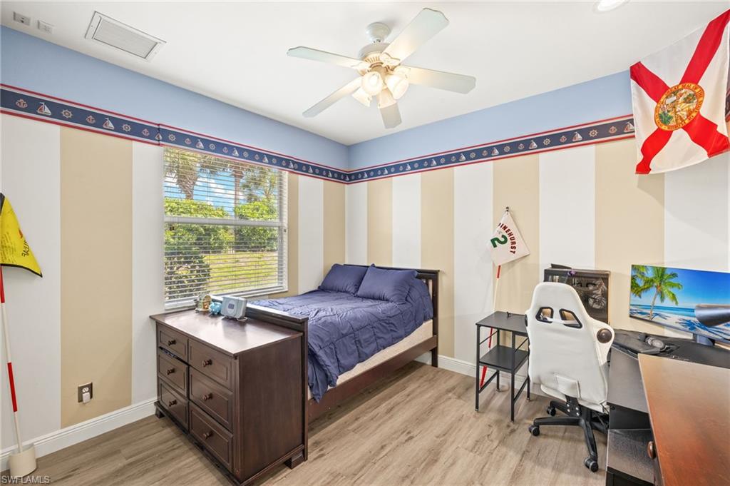 9890 Rookery Circle Estero, FL 33928 - Photo 20 of 26 a bed room with a bed and a chair