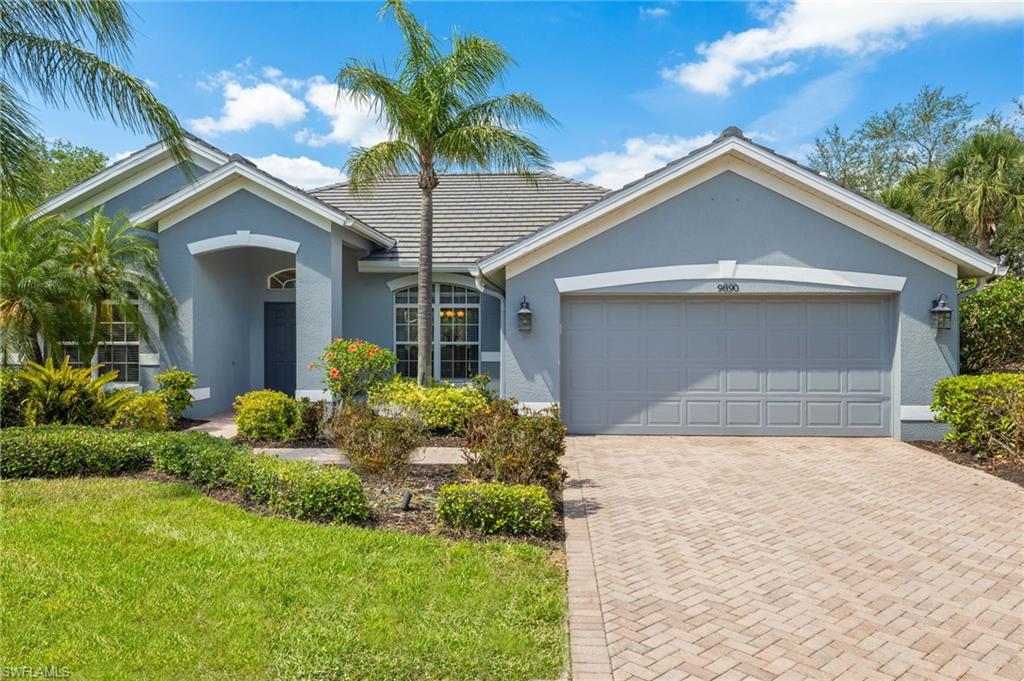 9890 Rookery Circle Estero, FL 33928 - Photo 2 of 26 front view of house with a yard and potted plants