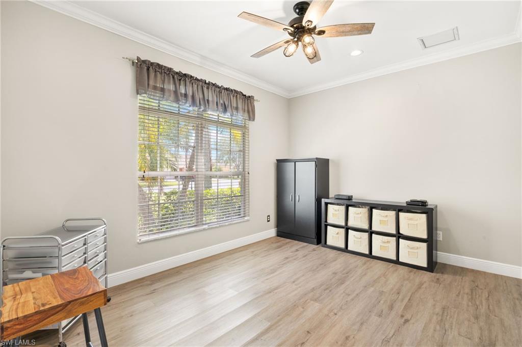 9890 Rookery Circle Estero, FL 33928 - Photo 21 of 26 a view of an empty room with a window and wooden floor