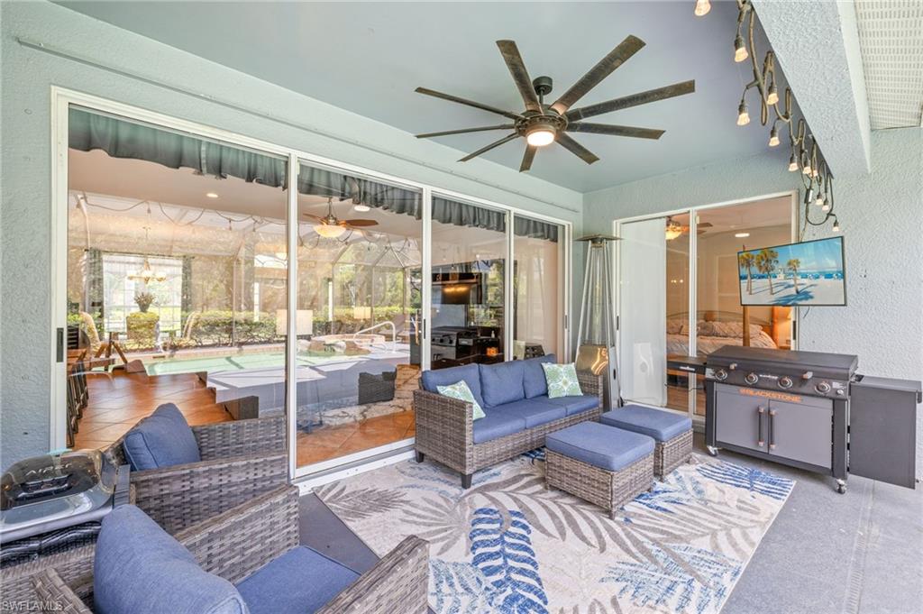 9890 Rookery Circle Estero, FL 33928 - Photo 22 of 26 a living room with furniture and a large window