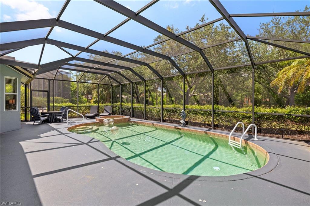 9890 Rookery Circle Estero, FL 33928 - Photo 24 of 26 a view of a swimming pool with a patio and a yard