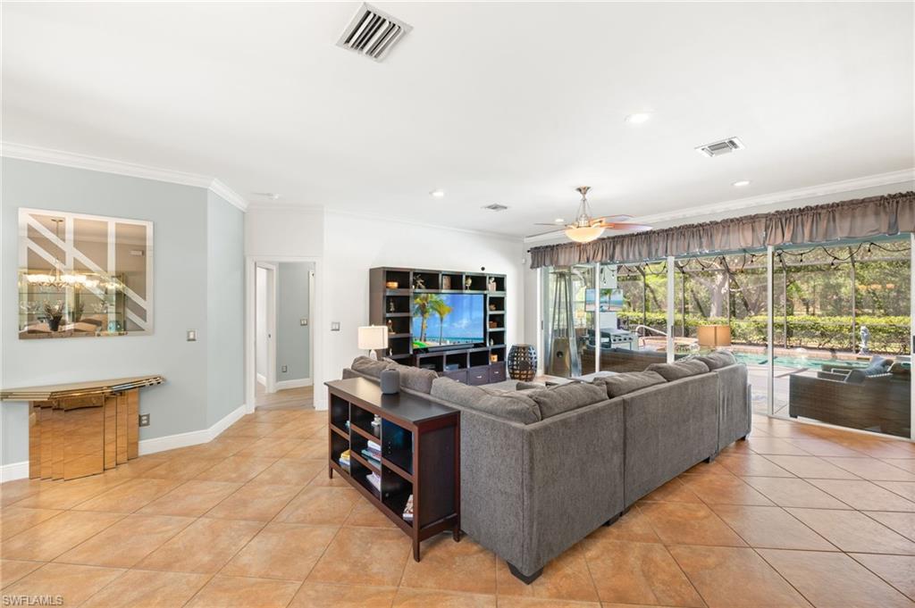 9890 Rookery Circle Estero, FL 33928 - Photo 5 of 26 a living room with furniture and a flat screen tv