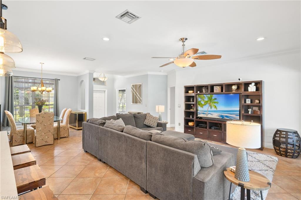 9890 Rookery Circle Estero, FL 33928 - Photo 6 of 26 a living room with furniture and a flat screen tv