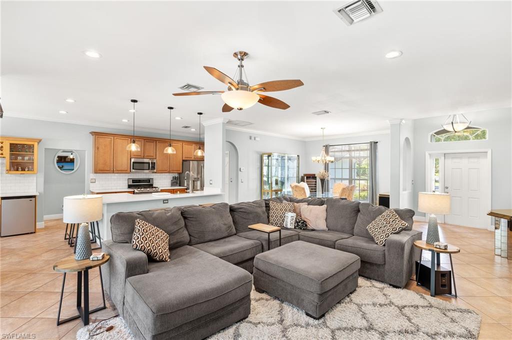 9890 Rookery Circle Estero, FL 33928 - Photo 7 of 26 a living room with furniture kitchen view and a chandelier