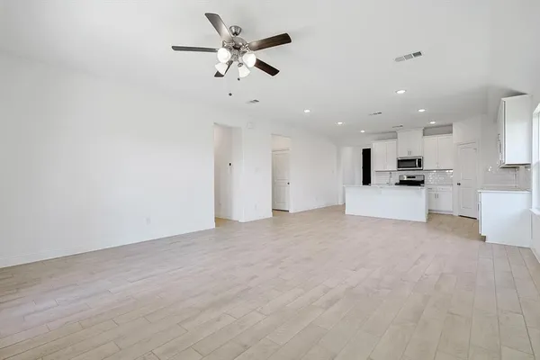 a view of a kitchen with a sink and a stove top oven