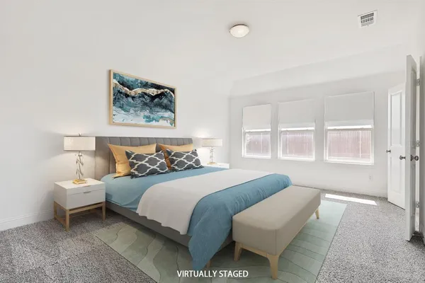 a bedroom with a bed and a large window