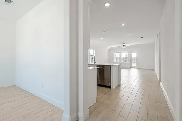 a view of a kitchen with a sink and wooden floor