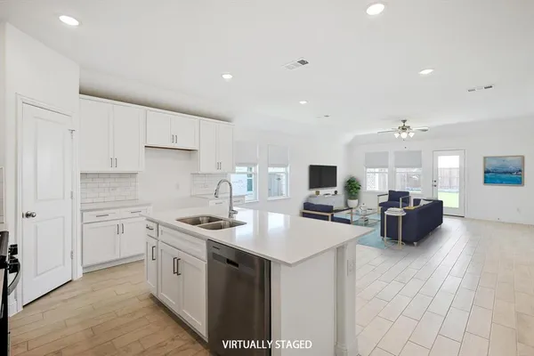 a kitchen with a sink dishwasher a stove top oven a counter space and cabinets