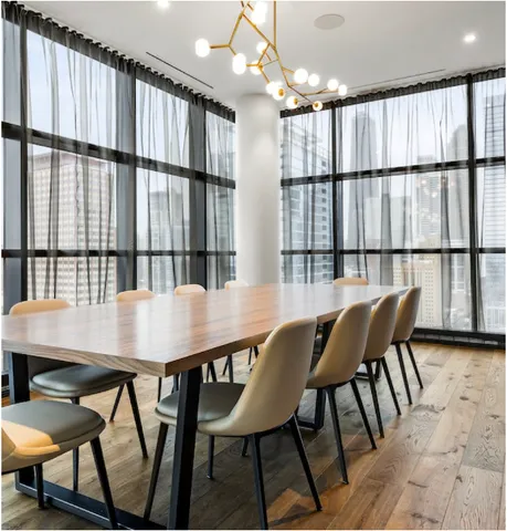 a view of a dining room with furniture and window