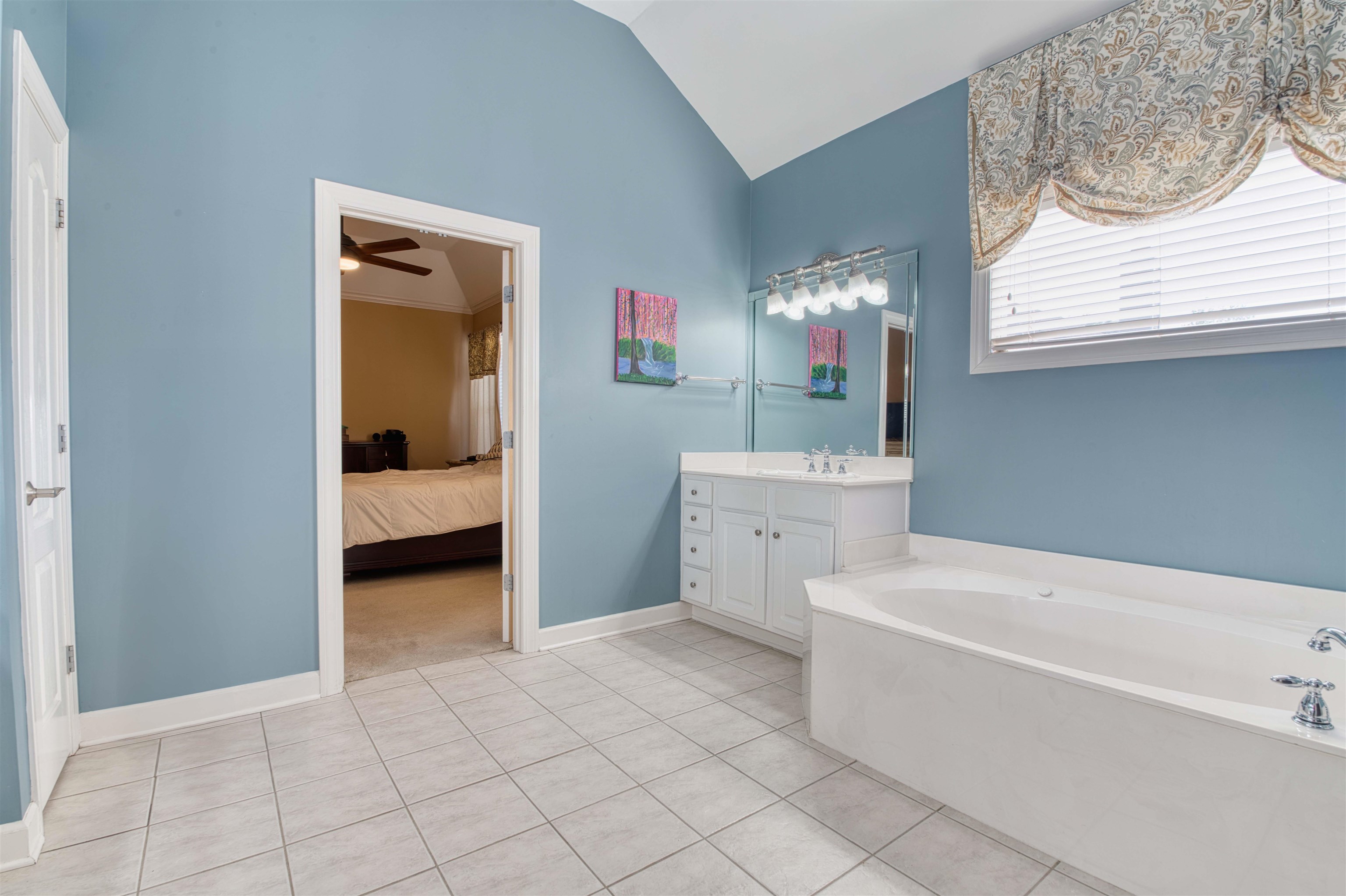 1630 Wolf Ridge Drive Collierville, TN 38017 - Photo 23 of 38 Ensuite bathroom featuring connected bathroom, tile patterned flooring, ceiling fan, vanity, and lofted ceiling