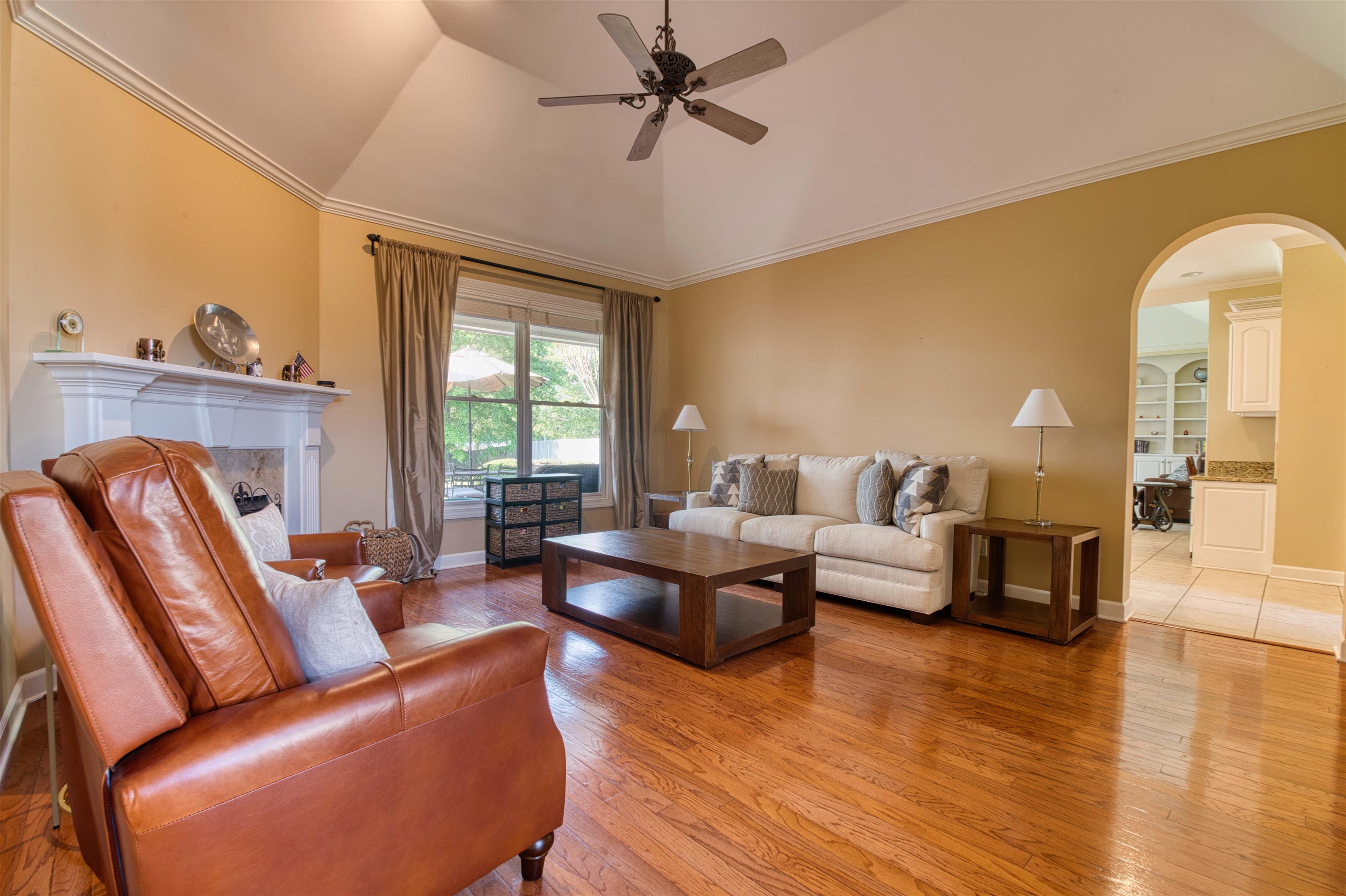 1630 Wolf Ridge Drive Collierville, TN 38017 - Photo 7 of 38 Living area with arched walkways, a ceiling fan, and light wood finished floors