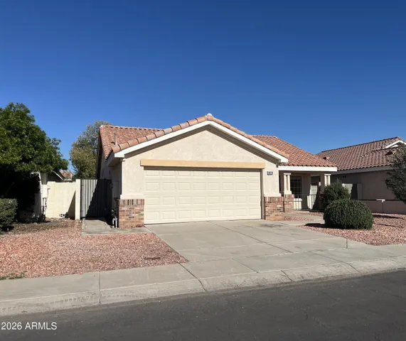 a view of a house with a yard and garage