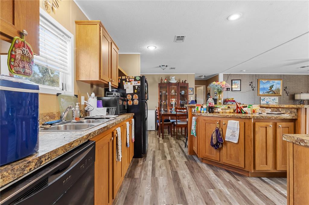 1650 Lyman Hendry Road, Unit 1 Perry, FL 32347 - Photo 14 of 30 a kitchen with stainless steel appliances granite countertop a stove and a sink